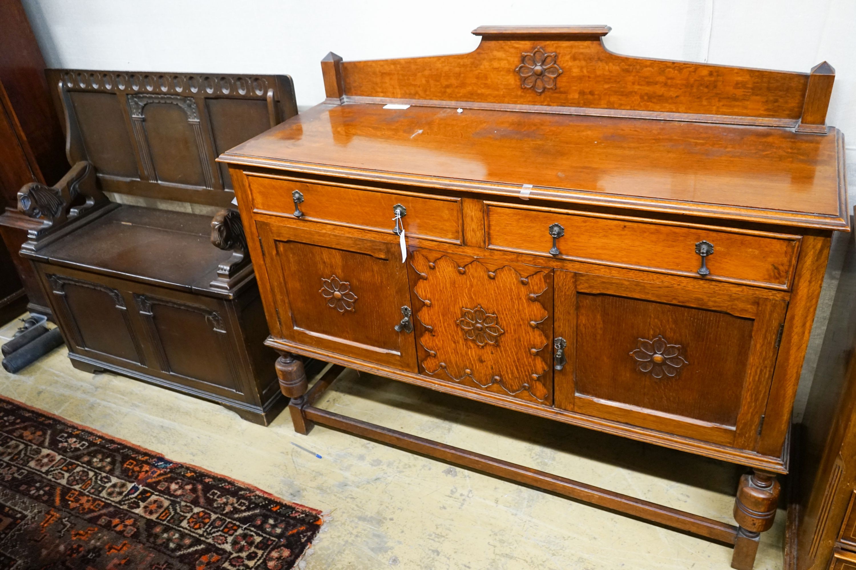 An 18th century style oak monks bench together with a 1920's oak sideboard